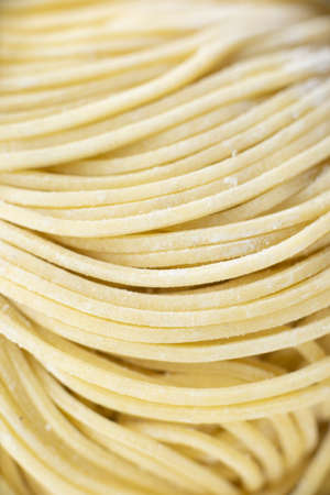 close up of raw uncooked chinese yellow egg noodle food background