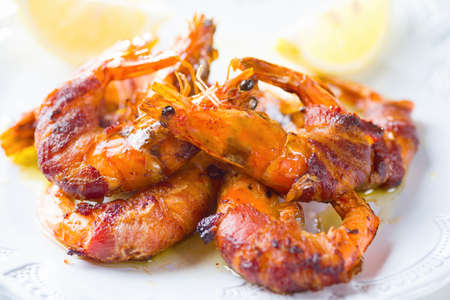 close up of grilled bacon wrapped prawn shrimp seafoodの写真素材