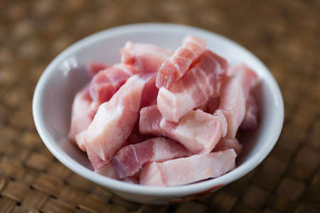 close up of a bowl of raw uncooked fatty meatの写真素材