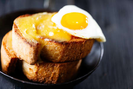 close up of pan of rustic french cheese toast with egg croque madameの写真素材