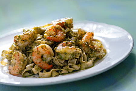 close up of a plate of seafood pasta in pesto sauceの写真素材
