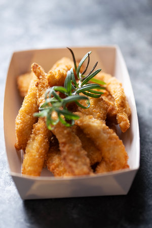 Close up of rustic pan fried breaded chicken tendersの写真素材