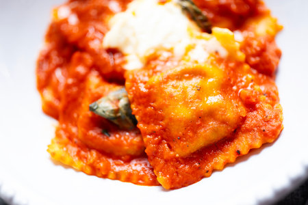close up of a bowl of italian ravioli pasta in tomato sauceの写真素材