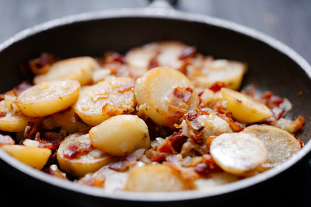 close up of traditional german pan-fried potatoes bratkartoffelnの写真素材