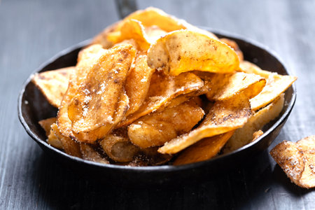 close up of a pan of golden fried potato cheese crisps
