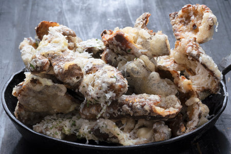 close up of a pan of cheesy italian potato skin crispsの写真素材