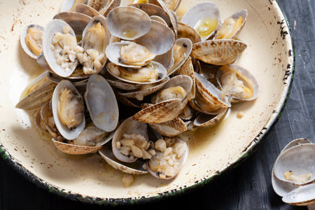 close up of plate of rustic vongole clams with white wine sauce