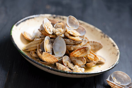 close up of plate of rustic vongole clams with white wine sauce