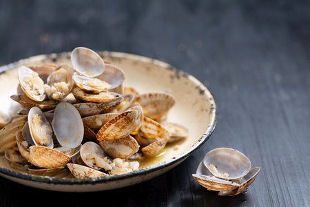 close up of plate of rustic vongole clams with white wine sauce
