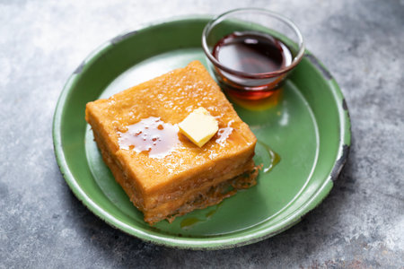 close up of a stack of french toast breakfast with syrup