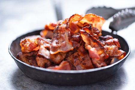close up of a rustic pan of bacon rashes