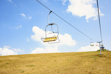 Lift seats in the Carpathians with clouds in the background. Summer timeの写真素材