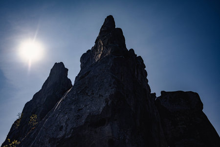 Unique Ukrainian Fortrress Tustan. Rock from the mountain over the sun and blue skyの写真素材