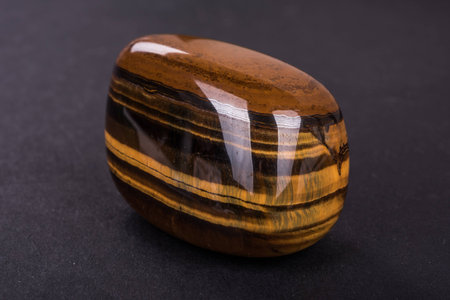 Tiger Eye geode on black backgroundの写真素材