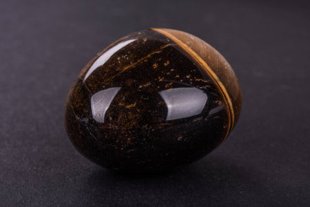 Tiger Eye geode on black backgroundの写真素材