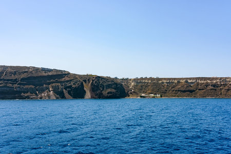 Tiny houses on top of Santorini islands in a deep blue sea. Greece in summer.の写真素材