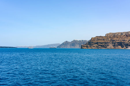 Boats with tourists near Santorini islands in a deep blue sea. Greece in summer.の写真素材