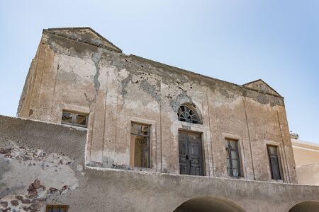 An old abandoned building in the Oia village on the Thira island, Santorini archipelago. Greece in summer.の写真素材