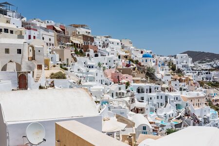 Tiny little white houses and small churches in the Oia village at Santorini, Greece.の写真素材