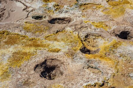 Hot geysers with mud and sulfur crystals in the volcano craterの写真素材