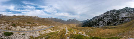 Beautiful panorama on top of Durmitor mountain. Serpentine road and unbelievable view to mountains of Montenegroの写真素材