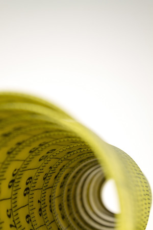Rolled old yellow tape measure