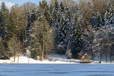 House on a frozen lake in winterの写真素材