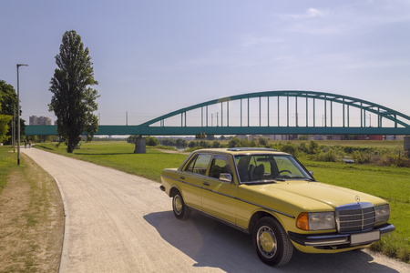 Old Mercedes car near a train bridgeのeditorial素材