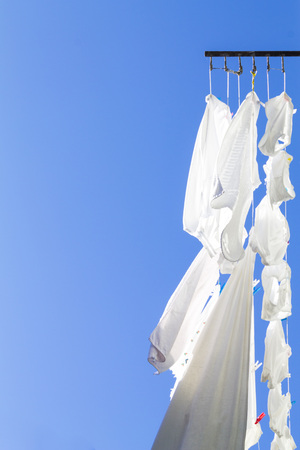 Drying laundry on a blue skyの写真素材