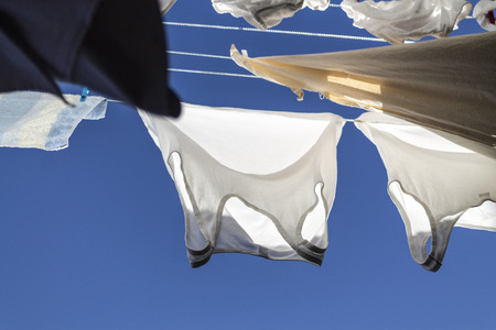 Drying laundry on a blue skyの写真素材