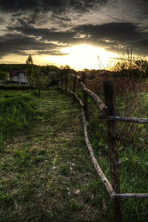 Fence in a field at sunriseの写真素材