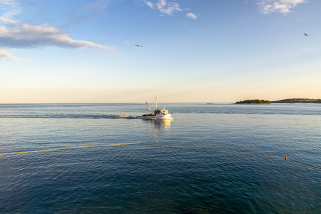 Fishing boat at sea on a sunny day in Croatiaの写真素材