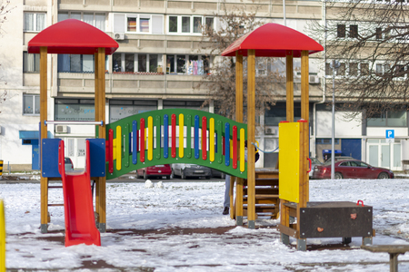 Empty playground in the public park in winterの写真素材