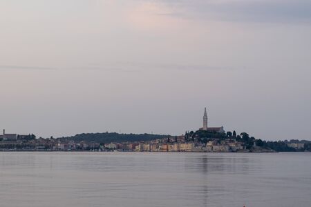 Fisherman before City of Rovigno on a gloomy morningの写真素材