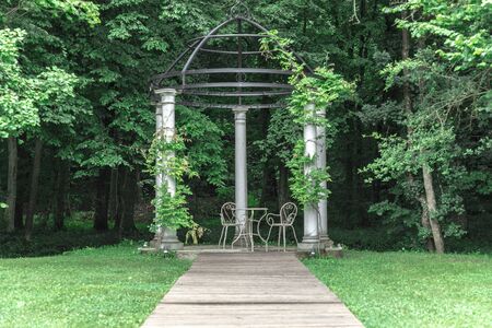 White gazebo for weddings in the woods on a cloudy dayの写真素材