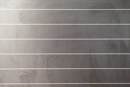 School black board with horizontal lines by natural light coming from one side
