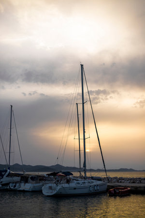 Small harbor with yacht and sail boats in Bibinje village at sunset in Croatiaの写真素材