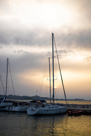 Small harbor with yacht and sail boats in Bibinje village at sunset in Croatiaの写真素材