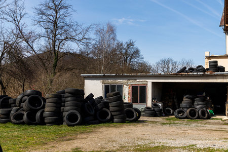 A pile of car tires in the house backyard on a sunny dayの写真素材