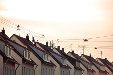 A row of houses on the roof of a residential building in the eveningの写真素材