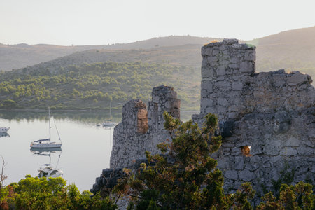 Ancient wall of Ostrica in Grabastica bay view at sunrise in Croatia