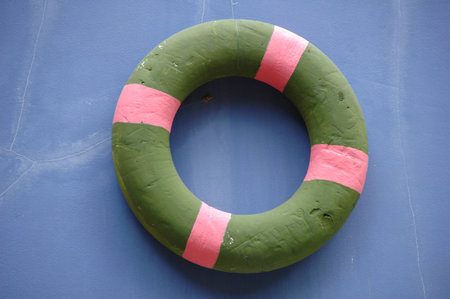 The green life buoy on the blue background の写真素材