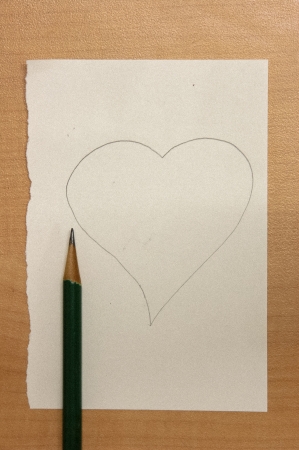 Heart on the paper drown by pencil to tell love の写真素材