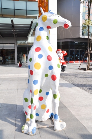 The colorful horse sit on the concrete in front of the shopping mall のeditorial素材