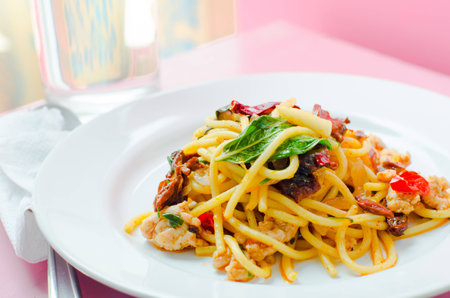 The menu of Fried spaghetti with chili with shellfish served in the white dish looks delicious.の写真素材