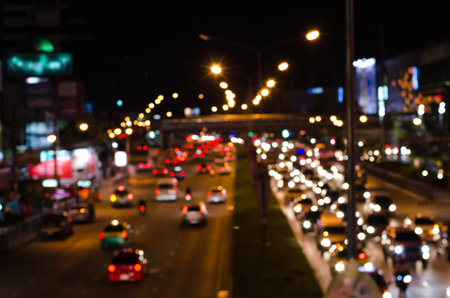The non-focus makes blur of the street at night. Everyone drive car along road.の写真素材