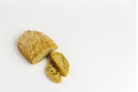 Homemade bread with seeds on a white background.