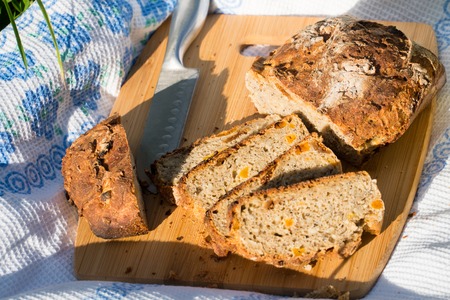 Delicious fresh bread on a board and tablecloth