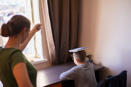 Mom scolds her son for not wanting to do homework.の写真素材