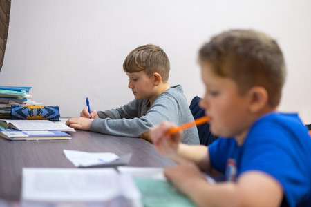 The brothers do their boring homework homework.